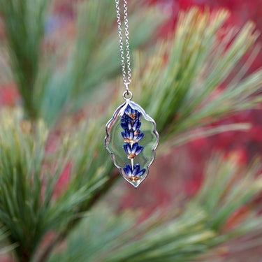 Lavender Sprig Necklace displayed against a garden-like background, highlighting delicate design, pendant details, and natural aesthetic