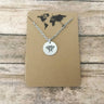 Bee necklace featuring small circular charm with delicate design