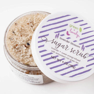 Lavender Blossom Body Sugar Scrub – Organic Lavender Orange front view, half-open to reveal scrub contents with lid showing the product label and packaging design
