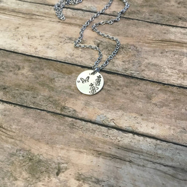 Lavender Butterfly necklace displayed on a lifestyle background