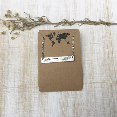 Lavender sprig bar necklace displayed on hang tag, showing design and packaging on a lifestyle background