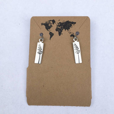 Lavender sprig earrings  displayed on a earring hang tag, showing design and packaging on a studio background