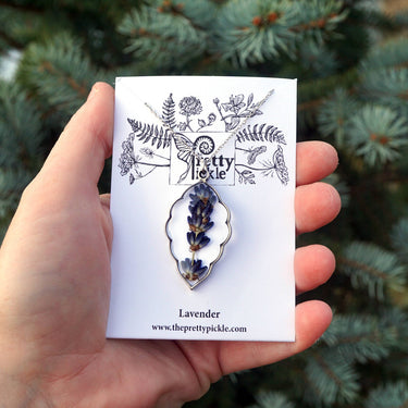 Lavender Sprig Necklace displayed against a garden-like background, highlighting delicate design, pendant details, and natural aesthetic