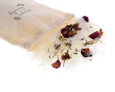 Pampering Lavender Passion Bath Salts Soak – Valentine’s Day edition shown in a lifestyle setting, open to reveal the colorful bath salts and showcasing product use in a relaxing environment