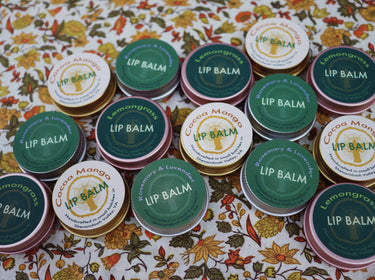 Rosemary & Lavender Lip Balm displayed alongside a variety of other lip balm flavors, showcasing different products and packaging designs